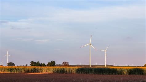 Premium Photo Wind Farm In The Field Wind Turbines Spin To Generate Electricity Alternative