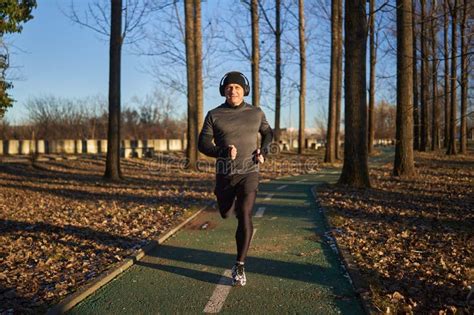Mature Man Running In The Park With Headphones Stock Image Image Of