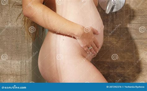 Nude Pregnant Woman Relaxing In Shower Under Streams Of Hot Water Concept Of Female Beauty