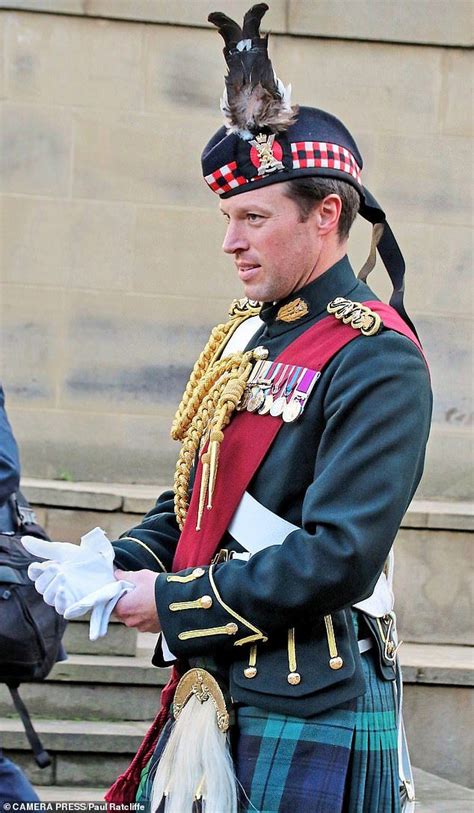 A Man In A Kilt Is Standing On The Steps With His Hand Out To Someone