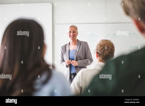 Smiling Mature Female Teacher Teaching In University Classroom Stock Photo Alamy