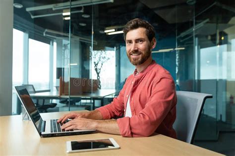 Portrait Of A Smiling And Successful Mature Man In The Office A