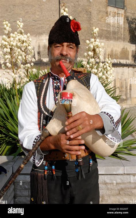 Man In Traditional Bulgarian Dress Playing A Gaida Bagpipe Stock Photo
