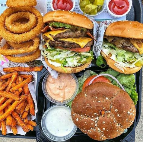 Two Hamburgers Fries And Onion Rings On A Tray