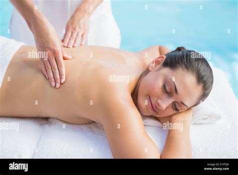 Happy Brunette Getting A Massage Poolside Stock Photo Alamy