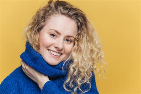 Close Up Shot Of Delighted Satisfied Female Model Has Curly Blonde Hair Broad Smile