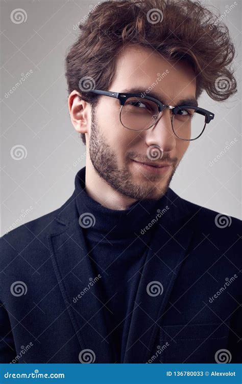 Handsome Elegant Man With Curly Hair Wearing Suit And Glasses Stock