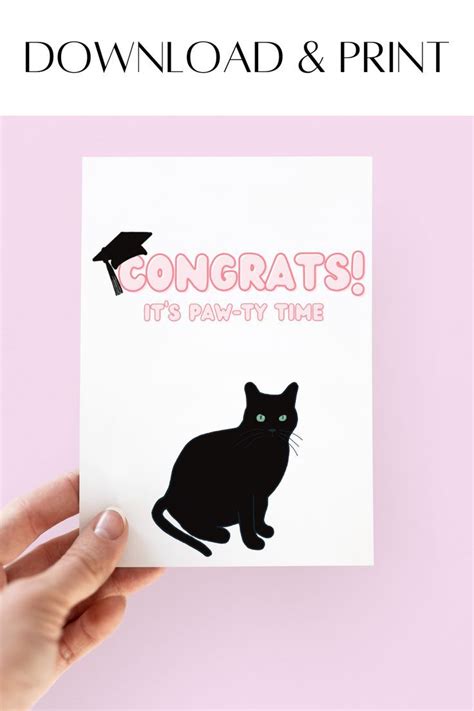 someone holding up a card with a black cat on it