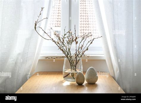 Pussy Willow Catkins And Flowering Branches In A Glass Vase And Artificial Eggs As Easter