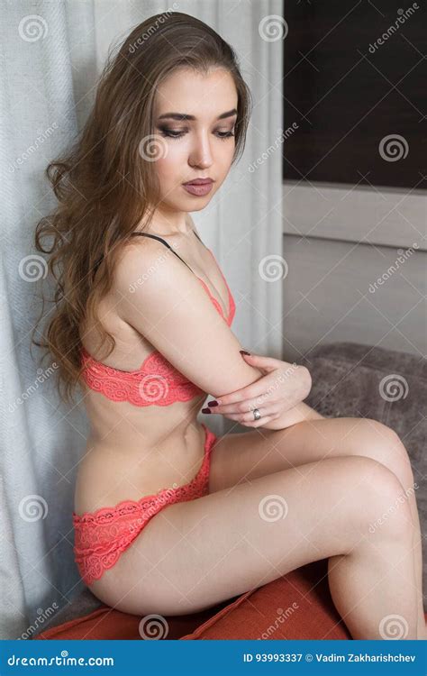 Sensual Brunette Is Sitting On The Couch In The Apartment Stock Image Image Of Breast Adult