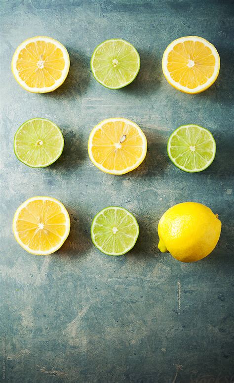 Food Lemons And Limes Cut In Half With One Full One By Stocksy