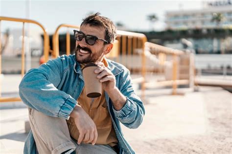 Premium Photo Close Up Of A Happy Man With Sunglasses Sitting At Pier