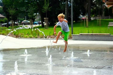 Premium Photo Full Length Of Boy Jumping Over Water Fountain