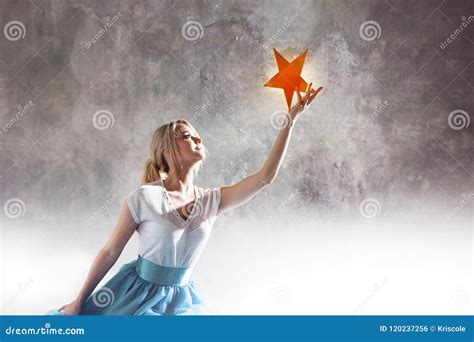 Young Attractive Woman Reaching For The Star Take A Star From The Sky