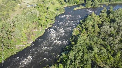 A fast stream of water carries a boat along the Southern Bug River ...