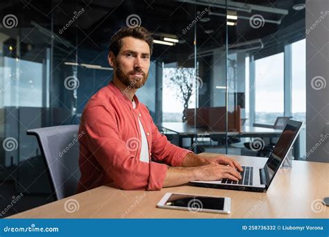 Portrait Of Mature Programmer Team Leader Man With Beard And In Red