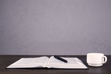 Open Bible. Holy Bible on the Table. Pen and Notepad. Cup White Stock ...