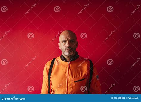 Astronaut with an Orange Space Suit on a Red Background Stock Photo ...