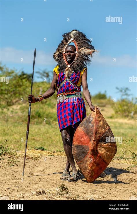 Masai Warrior Is Standing In Traditional Clothing In A Warriors