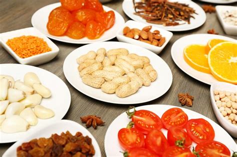 Premium Photo Different Products On Saucers On Wooden Table Closeup