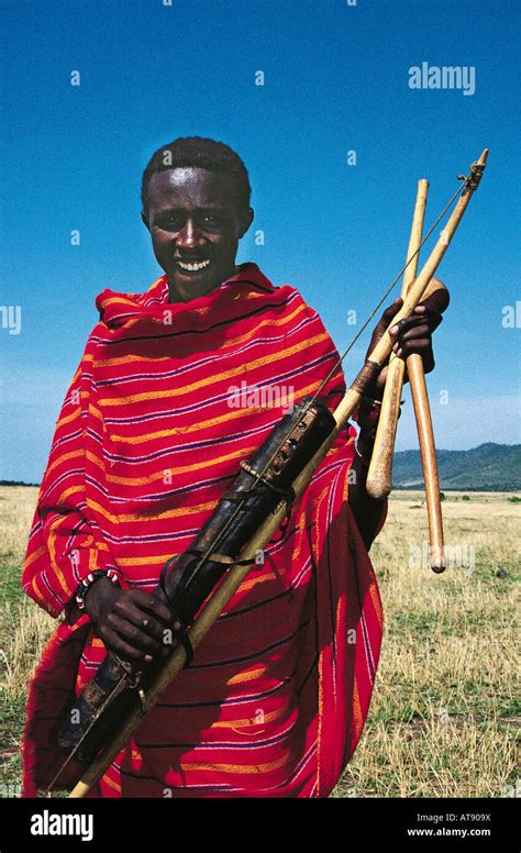 Young Maasai moran man with traditional bow and arrow weapons Masai ...