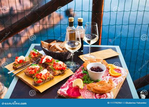 Romantic Dinner For Two At Sunset White Wine And Tasty Italian Stock