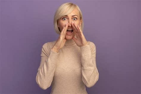 Free Photo Surprised Pretty Blonde Slavic Woman Holds Hands Close To Mouth Looking At Camera