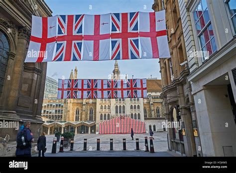 Union Jack flags and the flag of City of London suspended across a street near to the Guildhall ...