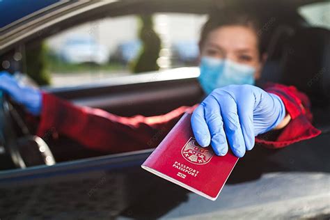 Woman Holding Red Passport Through Car Window Crossing Face Safety