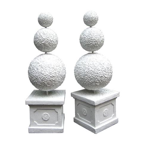 Two White Sculptures Sitting On Top Of Each Other