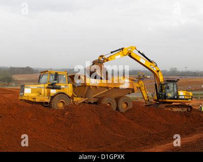 Jcb Excavator Digger Loading A Tipper Lorry With Earth From Basement