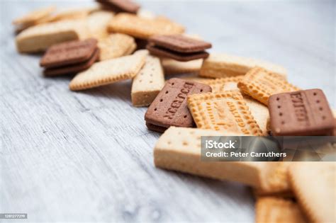 Closeup Of British Biscuits In A Row On A Rough Wooden Background With