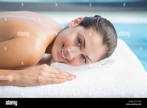 Smiling Brunette Lying On Massage Table Poolside Stock Photo Alamy