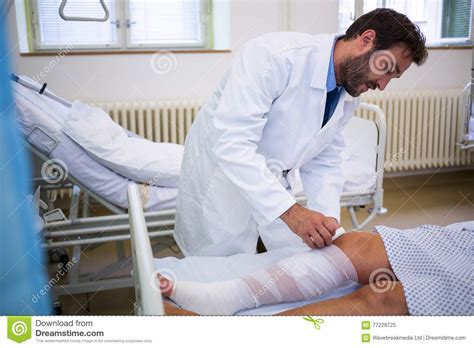 Doctor Bandaging Leg Of Patient Stock Image Image Of Lying Bandage