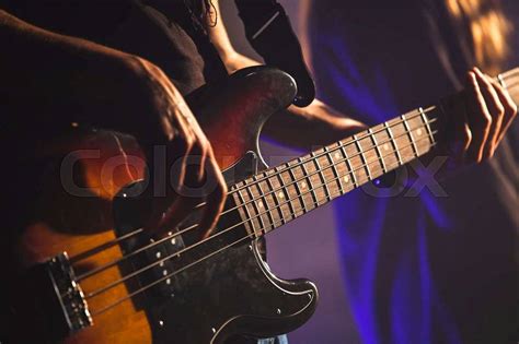 Closeup Photo Of Bass Guitar Player Hands Soft Selective Focus Live