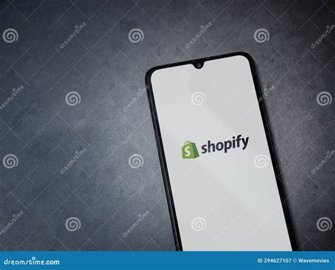 Shopify App Launch Screen On Smartphone On Dark Marble Stone Background