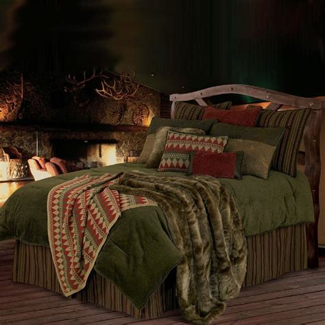 The Bed Is Made With Green And Brown Comforters Pillows And Throw