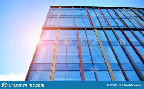 Modern Office Building With Glass Facade On A Clear Sky Background