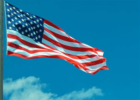 A large american flag flying in the sky photo – Free Flag Image on Unsplash