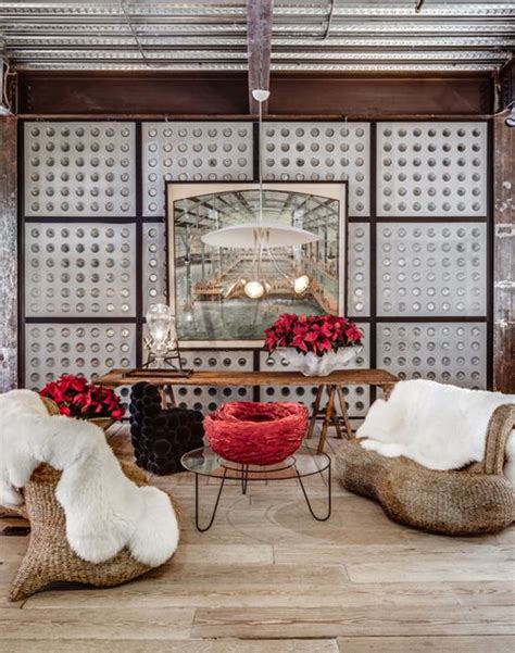 A Living Room With Two Chairs And A Table In Front Of A Large Mirror On