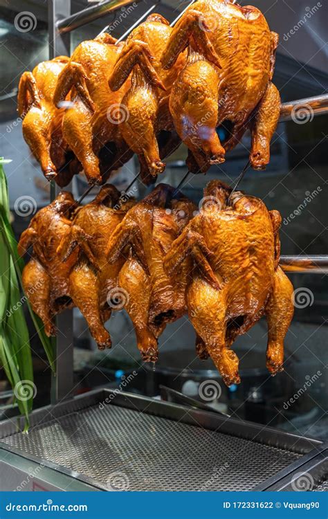 Whole Roasted Spicy Chickens Hanging In Chinese Restaurant`s Showcase