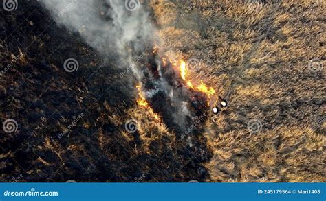 Aerial Drone View Flight Over Two Firefighters Putting Out Fire In