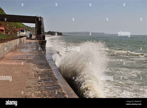 Waves Crashing Against The Seawall At Rockstone Bridge Dawlish As A