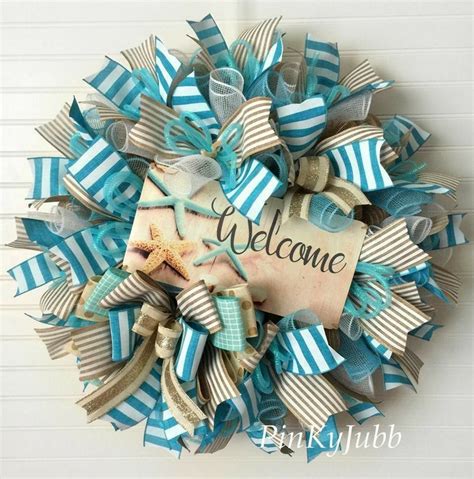 A Blue And White Welcome Wreath Hanging On A Wall