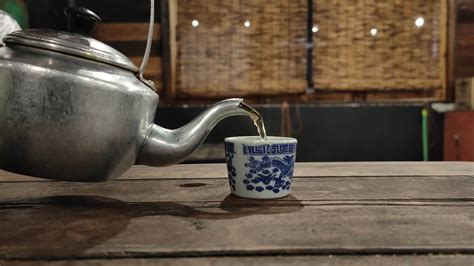 Footage Of A Teapot Pouring Hot Tea Into The Glass Causing White Steam 22133071 Stock Video At