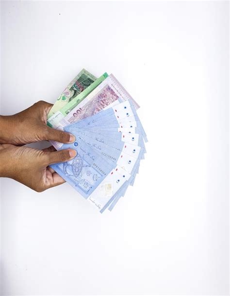 Premium Photo A Person Holding A Stack Of Euro Banknotes