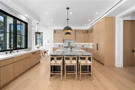 Modern Kitchen Featuring Wood Cabinets and an Island Countertop Stock ...