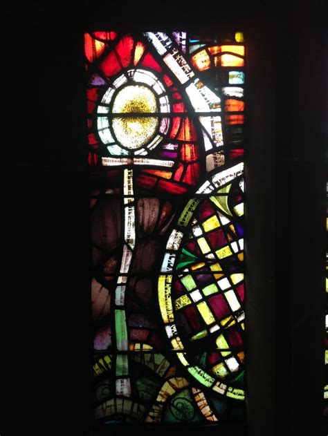 Two Large Stained Glass Windows In A Dark Room