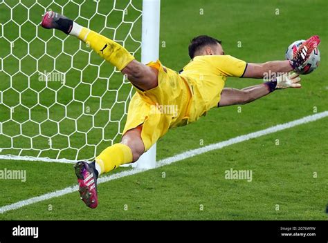 Italy goalkeeper Gianluigi Donnarumma saves from England's Jadon Sancho ...