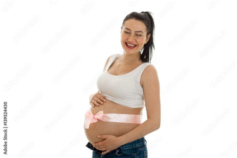 Happy Pregnant Brunette Girl In Big Belly Posing Isolated On White Background Stock Photo